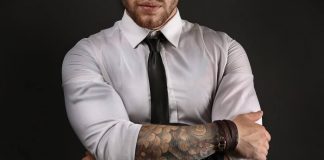 guy in dress shirt with tattoos on arms