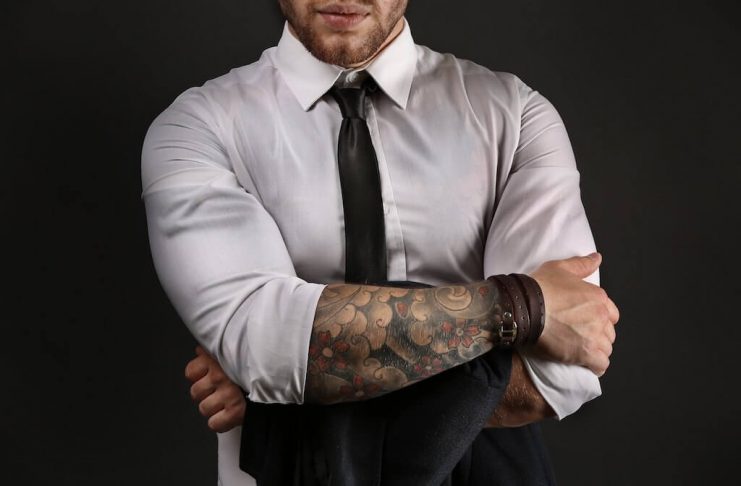 guy in dress shirt with tattoos on arms
